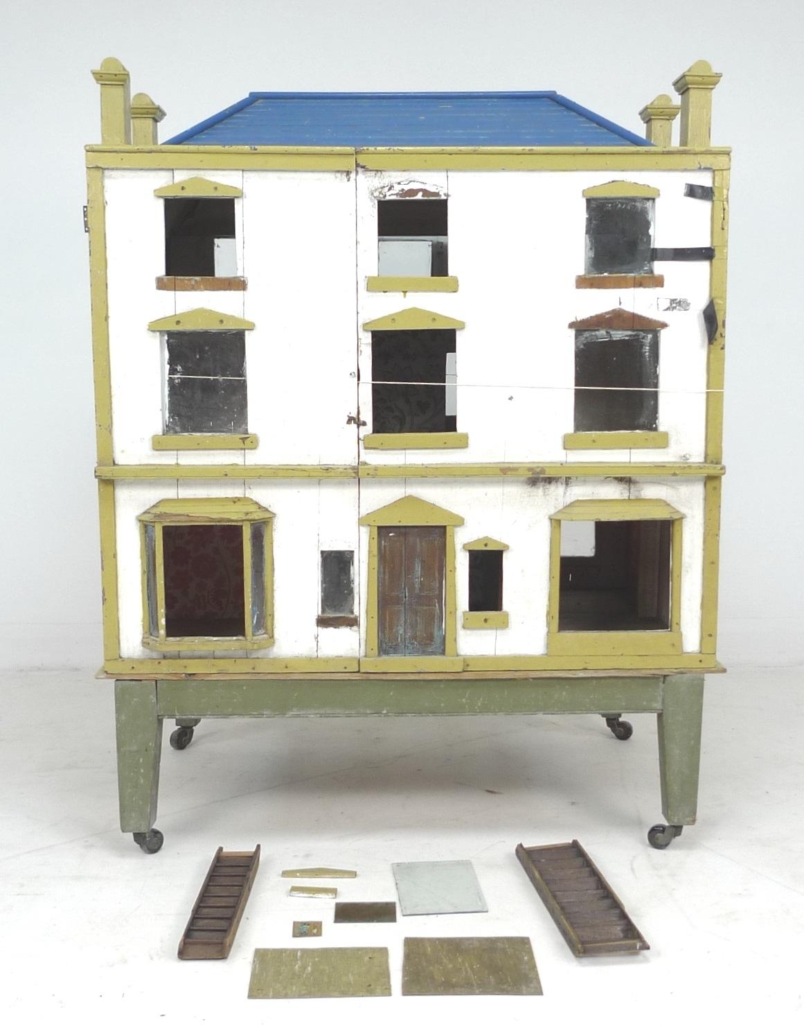 A 19th century Georgian Manor style Dolls house, with three storeys, accessible from both front