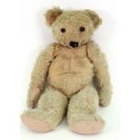 A vintage blonde plush Teddy bear, with