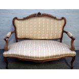 A Louis XV style stained beech open arm sofa with serpentine seat on scroll supports,