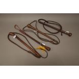 Three leather bull whips each with weighted terminals and braided leather whips and one further