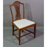 A George III mahogany shield back hall chair on tapering supports.