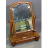 An early 20th century mahogany arch top single drawer toilet mirror on bun feet,