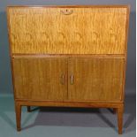 Gordon Russell; a 20th century teak side cabinet with fall front over two door cupboard,