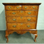 A George I figured walnut chest of two short and three long graduated drawers on later stand,