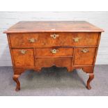 A George I and later figured walnut four drawer lowboy on pad feet, 99cm wide x 79cm high.