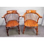 A pair of late 19th century oak and elm tub back smoker's bow armchairs, on turned supports,