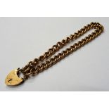 A 9ct gold solid curb link bracelet, on a 9ct gold heart shaped padlock clasp,
