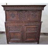 A 17th century and later carved oak court cupboard with pair of small cupboards over larger,