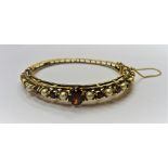 A 9ct gold, garnet and cultured pearl oval hinged bangle,