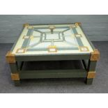 A 20th century square coffee table, the glass top inset with a Hermes scarf by A M Cassandre,