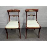 A set of six Regency brass inlaid faux rosewood dining chairs with bull's eye waist rail on sabre