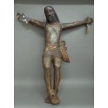 A polychrome decorated carved wooden figure of Jesus in crucifix position, 96cm high, (a.f.).