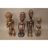 A West African hardwood figure carved carrying two flasks,