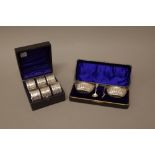 Silver, comprising; a set of six napkin rings, with scroll engraved decoration, Chester 1902,