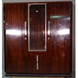 A mid-20th century mahogany side cabinet with central glazed door flanked by solid doors over pair