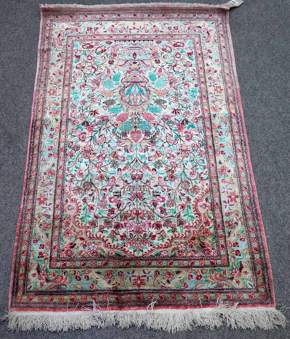 A Persian part silk prayer rug, white field with bird and floral design under a mihrab,