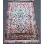 A Persian part silk prayer rug, white field with bird and floral design under a mihrab,