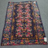 A Basarabian rug, the indigo field filled with bouquets of flower set in an indigo floral border,