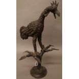 An African bronze cockerel, modelled on a leafy branch and domed foot, 65cm high.