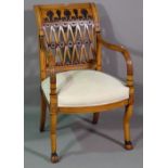 An 18th century style French fruitwood open armchair with lattice back on stylised hoof feet.