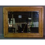 A large 20th century pine mirror, 105cm wide x 137cm high.