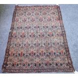 A Senneh rug, Persian, the ivory field with rows of flower filled vases, a leaf border,
