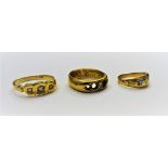 A gold and diamond set three stone ring,