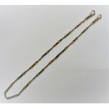 A two colour gold dress Albert chain, in an entwined and oval link design, fitted with two swivels,