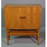 A 20th century teak side cabinet, with fitted interior on tapering supports, 68cm wide x 80cm high.