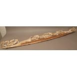A Maori Waka Taua (war canoe) softwood carved with oarsmen, traces of red and white pigment, 153cm.