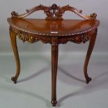 A 20th century carved hardwood demi-lune side table,