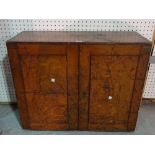 An early 20th century oak two door cabinet, 74cm wide x 60cm high.