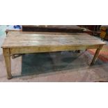 A 19th century oak plank top kitchen table on turned supports, 243cm long x 76cm high.