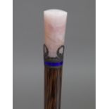 A silver and enamel mounted bamboo parasol handle with a rose quartz cylindrical handle, 30cm.