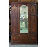 An Edwardian mahogany marquetry inlaid single door glazed wardrobe above a single drawer,
