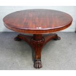 A William IV mahogany circular snap top breakfast table, on lion's paw feet,