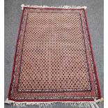 A fine Indian rug, the field with a honeycomb of botehs within a complementary madder border,