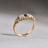 A gold, sapphire and diamond set half hoop ring, mounted with three cushion shaped sapphires,