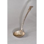 A William IV silver Kings pattern soup ladle, the oval bowl with scallop fluted decoration,