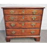 A mid-18th century small oak chest of four long graduated drawers on bracket feet,