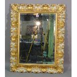 A 20th century Italian style gilt framed rectangular mirror with scroll decoration,