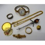 A 9ct gold circular cased lady's wristwatch, on a gilt metal fronted expanding metal bracelet,