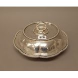 An Egyptian shaped circular lidded entree dish, of lobed form,