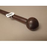 A South African hardwood long stick, with spherical pommel over a cylindrical shaft, 148cm.