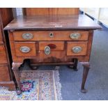 A mid-18th century walnut and mahogany lowboy with five frieze drawers on club supports,