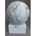 A white marble sphere or pier finial, on a dished square stand, sphere 22cm diameter.