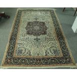 An Indian rug, the ivory field with a burgundy central medallion, palmette spandrels,