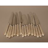 A set of eight table knives,