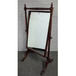 A late George III mahogany cheval mirror on turned columns and four downswept supports,