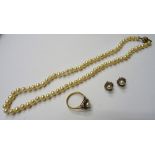 A single row necklace of cultured pearls, on a gold and diamond set clasp, detailed 375, a 9ct gold,